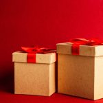 Two Brown-and-red Gift Boxes on Red Surface