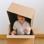 Boy Playing With Boxes